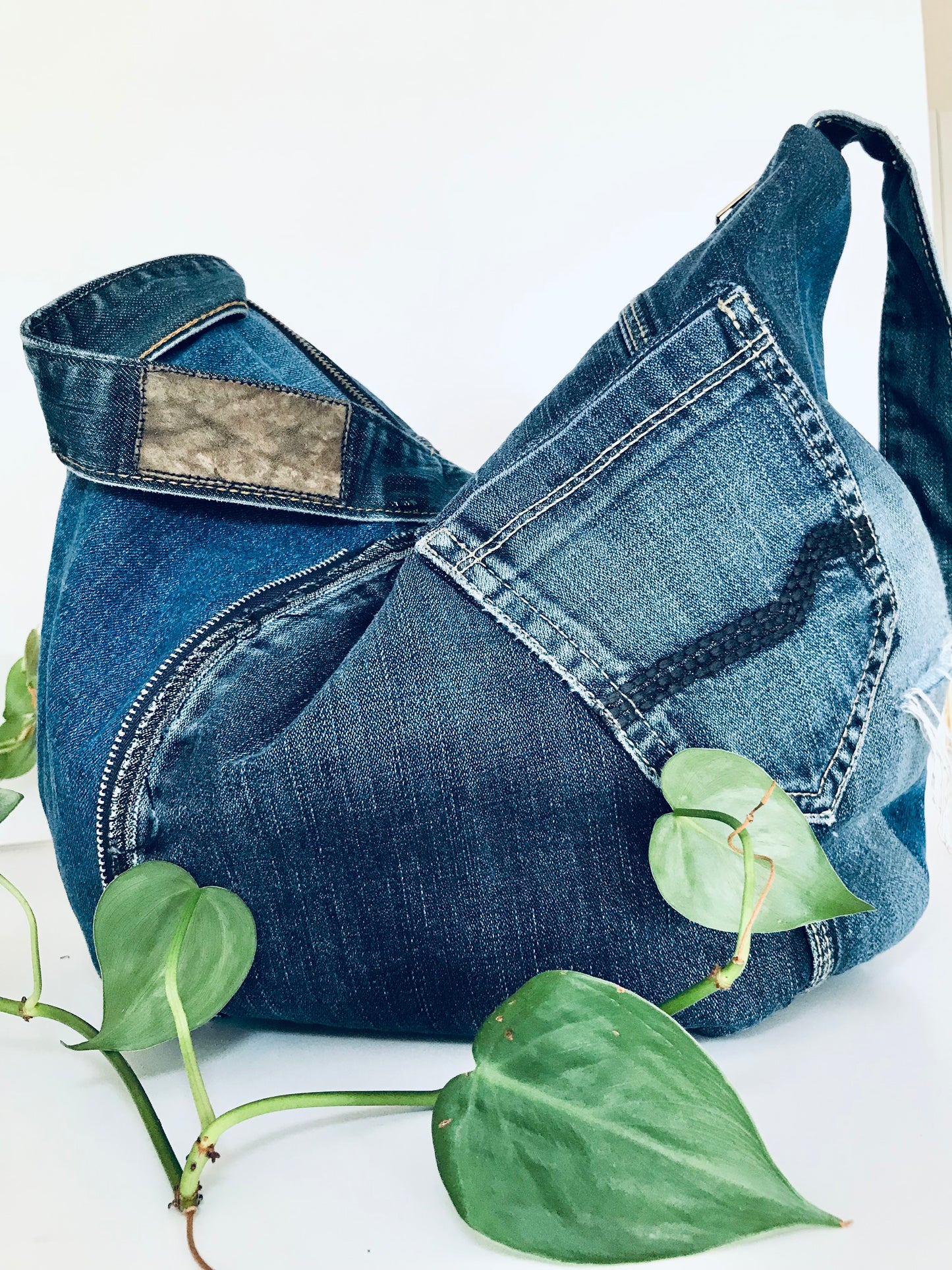 Upcycled edgy denim hobo bag with seam and zipper detail