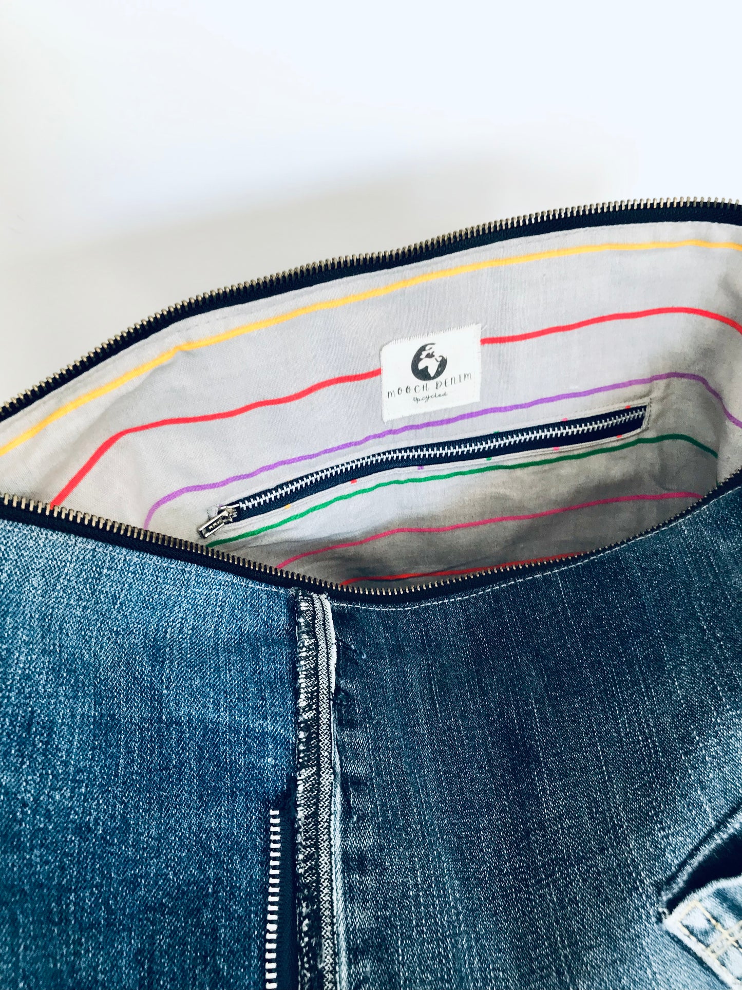 Upcycled edgy denim hobo bag with seam and zipper detail
