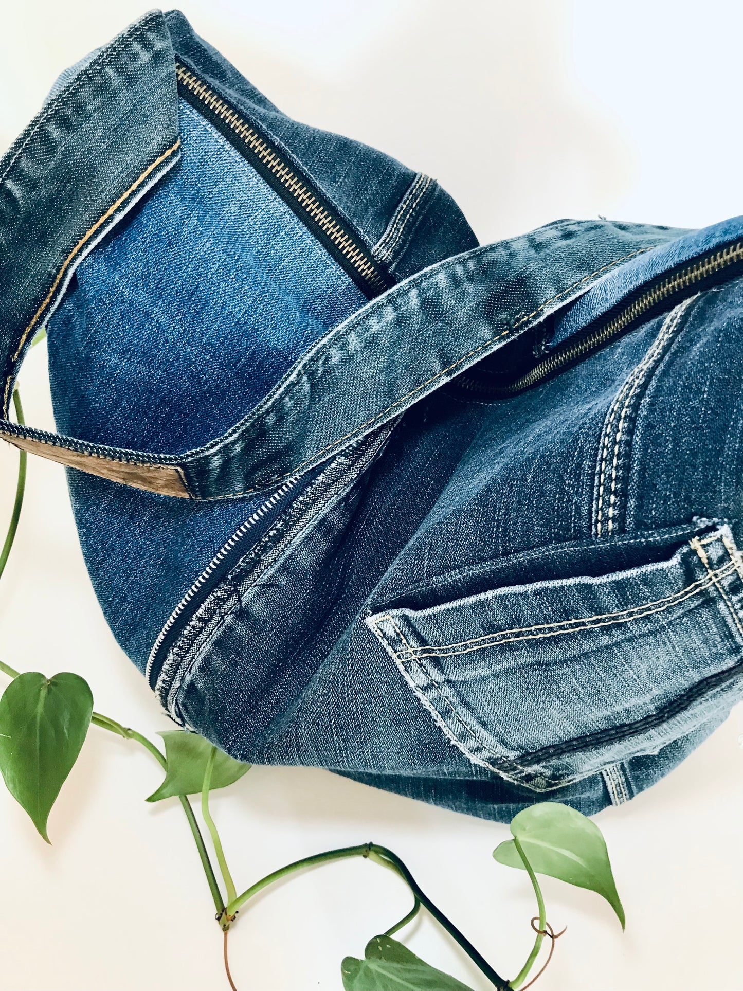 Upcycled edgy denim hobo bag with seam and zipper detail