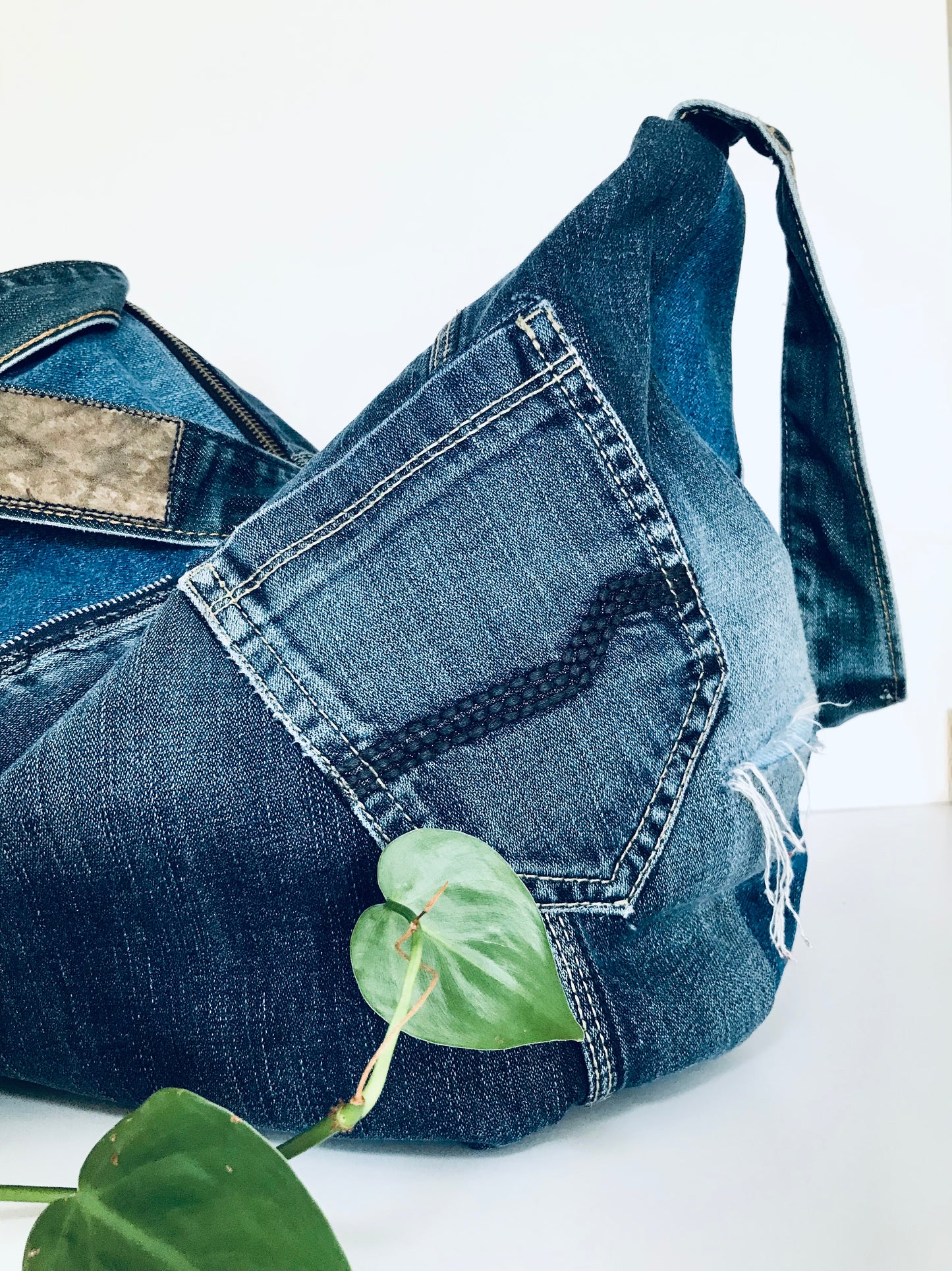 Upcycled edgy denim hobo bag with seam and zipper detail