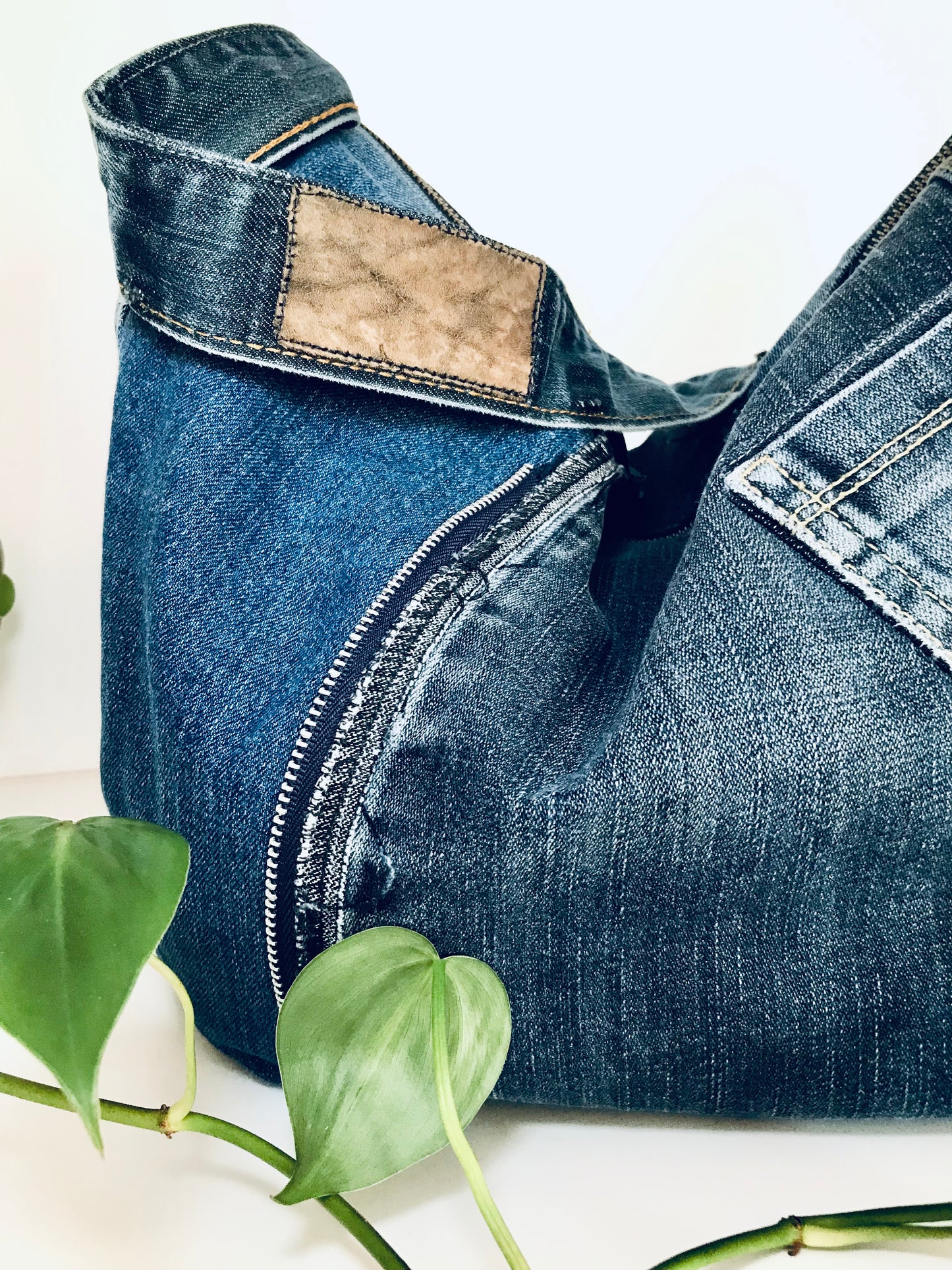 Upcycled edgy denim hobo bag with seam and zipper detail